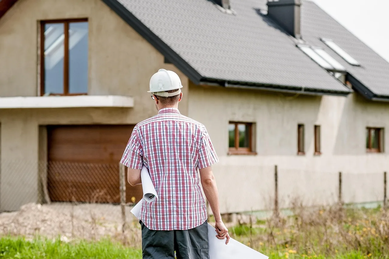 Builder reviewing construction drawings on UK building site